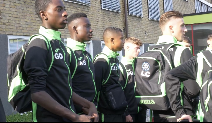 Elite players standing in their tracksuits.